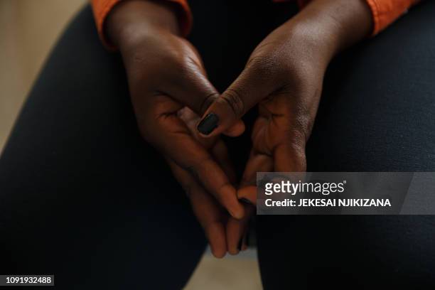 Rape survivor wrings her hands as she relates how she was abused by soldiers at her home, fearing that these same perpetrators would return to repeat...