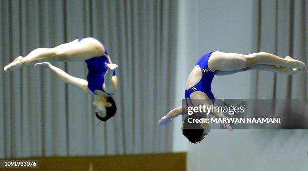 Hong thanh Tra and Mai Thi Yen of Vietnam perform during the women's 3m sychronized diving final at Sajik pool in Busan, 08 October 2002, during the...