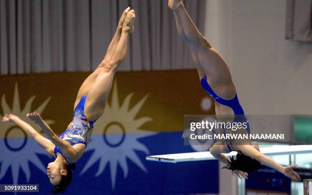 Mayumi Higuchi and Ryoko Nishii of Japan perform during the women's 3m sychronized diving final at Sajik pool in Busan, 08 October 2002, during the...