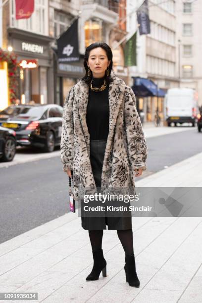 Model and Actress Betty Bachz wears a leopard print faux fur coat with a leather skirt and black boots during London Fashion Week Men's January 2019...