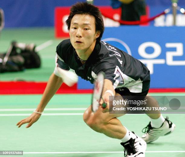 South Korea's Lee Hyun-Il dives for a return against Indonesia's Taufik Hidayat during their men's badminton singles final at the 14th Asian Games in...