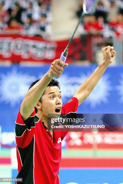 Indonesia's Taufik Hidayat throws his fists in the air as he defeats South Korea's Lee Hyun-Il in the men's badminton singles final at the 14th Asian...