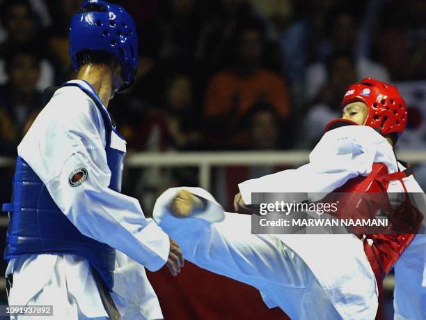 Gold medalist Moon Dae-Sung of South Korea attempst a side kick againt Nguyen Van Hung of Vietnam during their final match in the taekwondo men's...