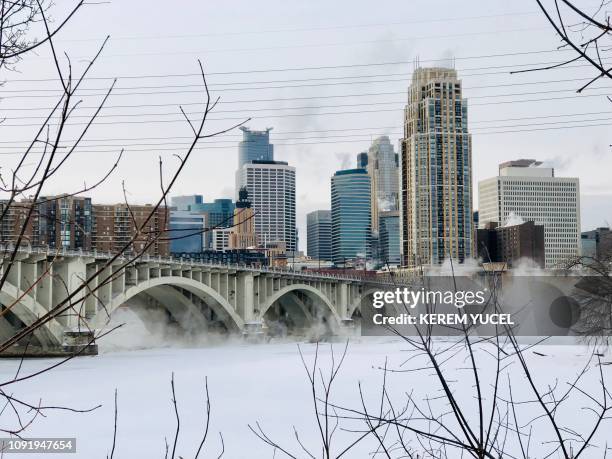 Water vapor rises above St. Anthony Falls on the Mississippi River beneath the Stone Arch Bridge during frigid temperatures on January 31, 2019 in...