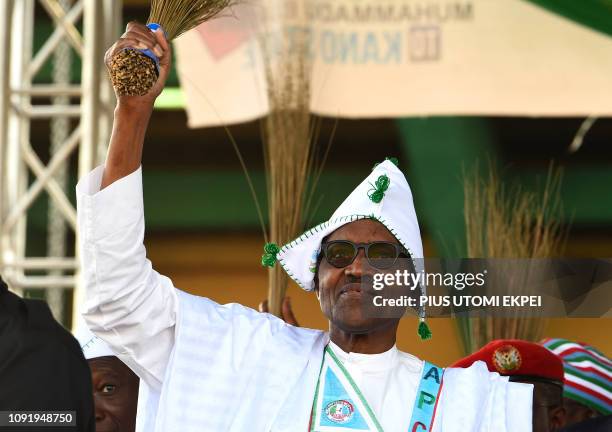 Candidate of the ruling All Progressives Congress , incumbent President Mohammadu Buhari waves the broom, symbol of the party, during his campaign...