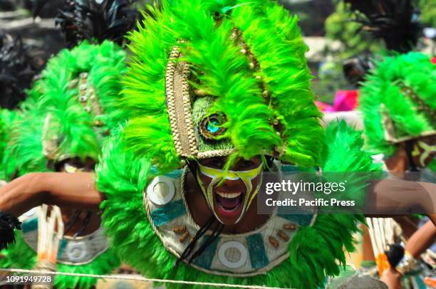 The dancers are wearing colorful costumes and headdress matching with their face and body paint according to their tribe. The Dinagyang Festival of...