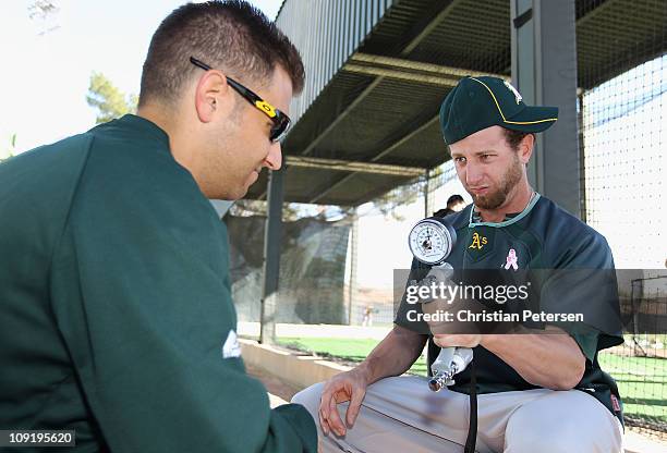 Pitcher Dallas Braden of the Oakland Athletics participates in a hand strength drill during a MLB spring training practice at Phoenix Municipal...