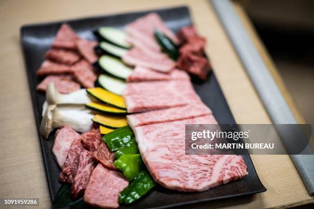 This picture taken on October 13, 2018 shows wagyu beef being served at a restaurant in Takayama. In a lush field in the heart of the Japanese...