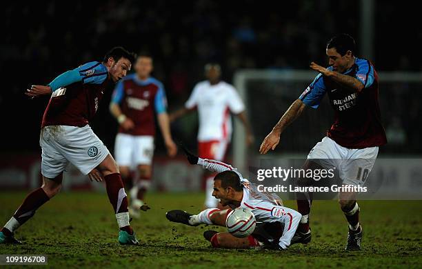 Marcus Tudgay of Nottingham Forest battles with Andy Hughes of Scunthorpe during the npower Championship match between Scunthorpe United and...