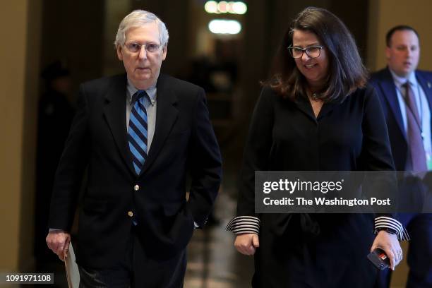 Senate Majority Leader Mitch McConnell walks towards the Senate chamber with Senate Secretary for the Majority Laura Dove at the U.S. Capitol January...