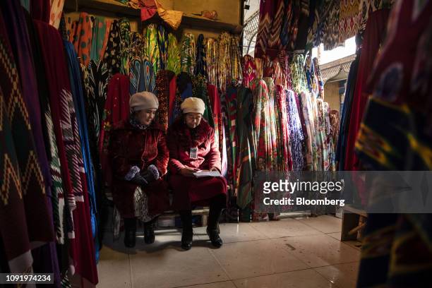 Vendors sit in a fabric stall inside the main bazaar in Kashgar, Xinjiang autonomous region, China, on Thursday, Nov. 8, 2018. Although it represents...