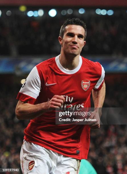 Robin van Persie of Arsenal celebrates Arsenal's first goal during the UEFA Champions League round of 16 first leg match between Arsenal and...