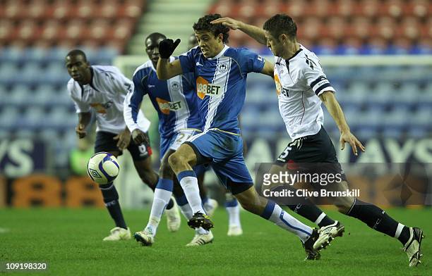 Franco Di Santo of Wigan Athletic holds off a challenge from Gary Cahill of Bolton Wanderers during the F.A Cup sponsored by E.ON 4th round replay...