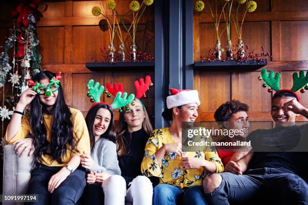 generation z christmas party with multi-ethnic friends - bois noel stock pictures, royalty-free photos & images