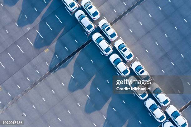 the aerial photograph of the outdoor warehouse of the new car. - car manufacturing fotografías e imágenes de stock
