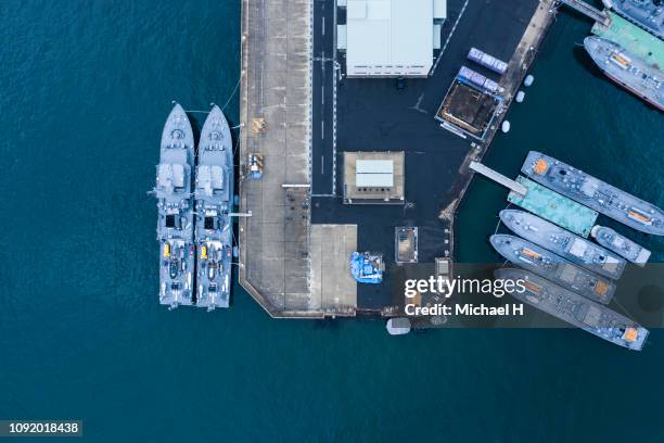aerial shooting of warships anchored in the harbor. - marine-base stock pictures, royalty-free photos & images