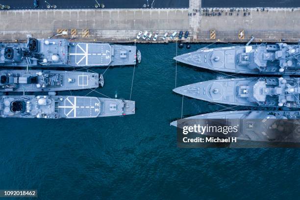 aerial shooting of warships anchored in the harbor. - military base drone stock pictures, royalty-free photos & images