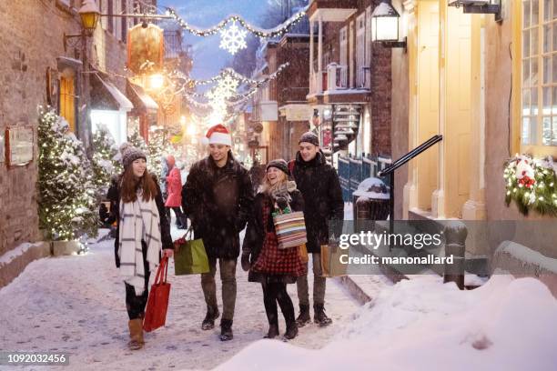 multi-ethnic generation z friends shop for christmas holiday - winter quebec stock pictures, royalty-free photos & images