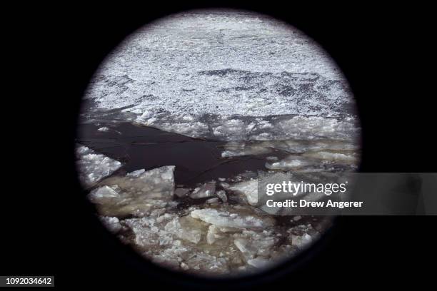 View out the window of the USCGC Penobscot Bay, an icebreaking tugboat of the U.S. Coast Guard, as it cuts through ice and makes its way north on the...