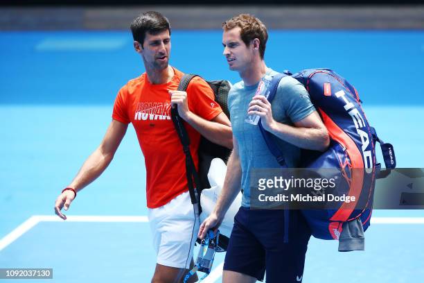 Novak Djokovic of Serbia talks with Andy Murray of Great Britain before their practice match ahead of the 2019 Australian Open at Melbourne Park on...