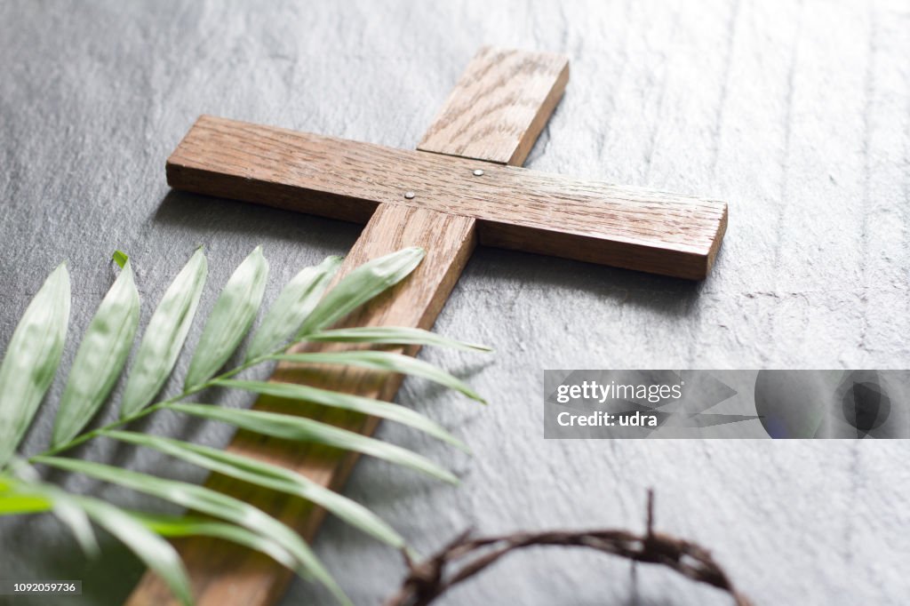 Easter wooden cross on black marble background religion abstract palm sunday concept