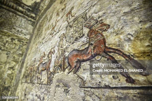 This picture taken on February 1, 2019 shows an inscribed painting of an Egyptian chariot with hieroglyphics, at the tomb of the ancient Egyptian...