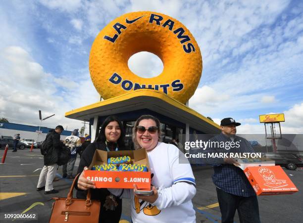 Rams fans Katelyn and Nancy Delgado show their team themed donuts outside the iconic Randy's Donuts Inglewood store, February 1 ahead of this...