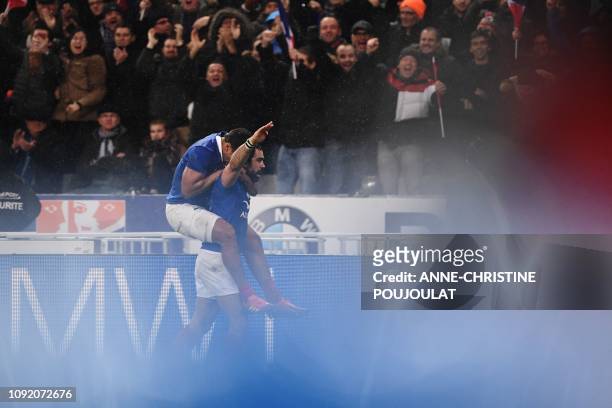 France's winger Yoann Huget celebrates with France's center Wesley Fofana after scoring a try during the Six Nations rugby union tournament match...