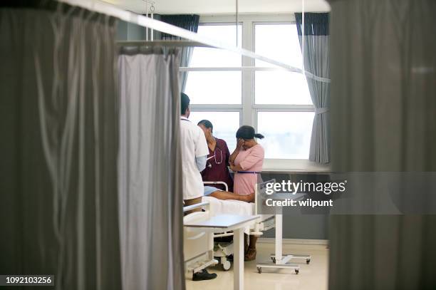 doctor sharing bad news with family member - hiv doctor stock pictures, royalty-free photos & images