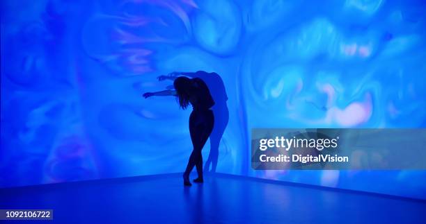 multicolor background projection upon a female dancer - projection equipment stock pictures, royalty-free photos & images