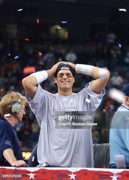 New England Patriots quarterback and Super Bowl MVP Tom Brady reacts on the podium following New England's upset victory over the St. Louis Rams in...