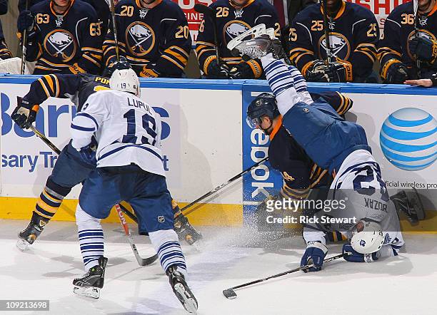 Tyler Bozak of the Toronto Maple Leafs flips over Andrej Sekera of the Buffalo Sabres at HSBC Arena on February 16, 2011 in Buffalo, New York.