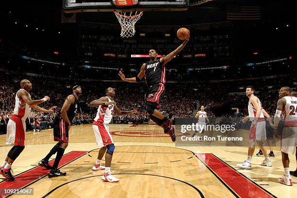 Chris Bosh of the Miami Heat dunks against Ed Davis of the Toronto Raptors during a game on February 16, 2011 at the Air Canada Centre in Toronto,...