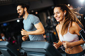 Sporty people running on treadmills in a health club