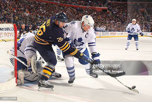 Thomas Vanek of the Buffalo Sabres battles for the puck against Don Phaneuf and James Reimer of the Toronto Maple Leafs at HSBC Arena on February 16,...