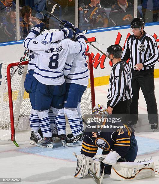 Mike Komisarek, Dion Phaneuf, Tim Brent and Joey Crabb celebrate Crabb's game winning goal behind Ryan Miller of the Buffalo Sabres the Toronto Maple...