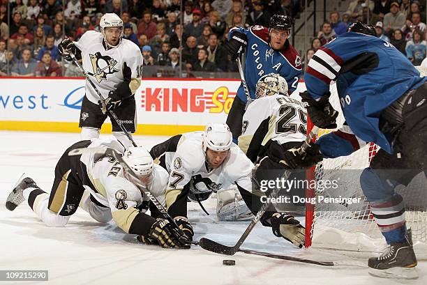 Zbynek Michalek and Michael Rupp of the Pittsburgh Penguins help goalie Marc-Andre Fleury defend the goal as Kevin Shattenkirk of the Colorado...
