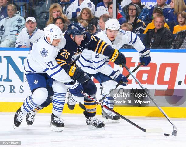 Thomas Vanek of the Buffalo Sabres tries to sneak between Tim Brent and Luke Schenn of the Toronto Maple Leafs at HSBC Arena on February 16, 2011 in...