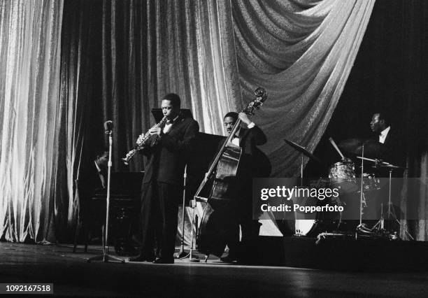 American jazz saxophononist, composer and musician John Coltrane performs live on stage with, from left, pianist McCoy Tyner, bassist Reggie Workman...