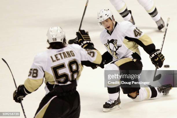 Tyler Kennedy of the Pittsburgh Penguins celebrates his game winning goal in overtime with Kris Letang against the Colorado Avalanche at the Pepsi...