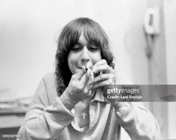 Iggy Pop lighting a pipe at the MC5 house at 1510 Hill Street in Ann Arbor, MI, in 1968.