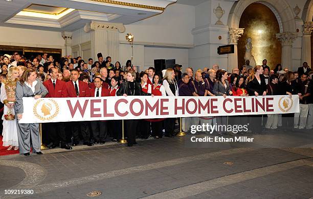 Caesars Palace employees hold a welcome sign as they wait for singer Celine Dion to arrive at the resort February 16, 2011 in Las Vegas, Nevada. Dion...