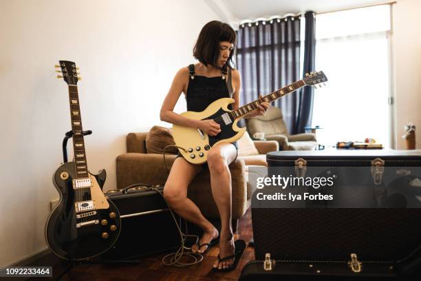 filipino musician playing the guitar - performer stock-fotos und bilder