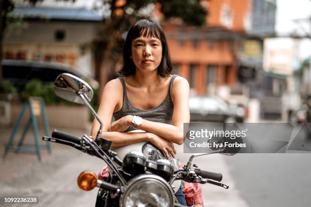 filipino motorcyclist on motorcycle - filipino woman stock-fotos und bilder