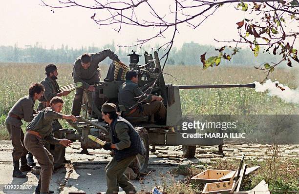 Serb volunteers load a cannon on the front line during the fighting for Vukovar against the Croatian forces 05 October 1991 in Borovo Selo. AFP PHOTO...
