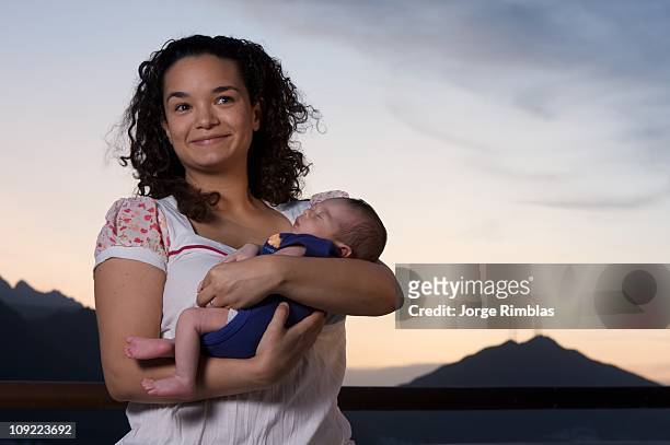 proud mother holding newborn boy - rimblas stockfoto's en -beelden