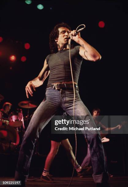 Bon Scott performs on stage with AC/DC, UK, 1976.