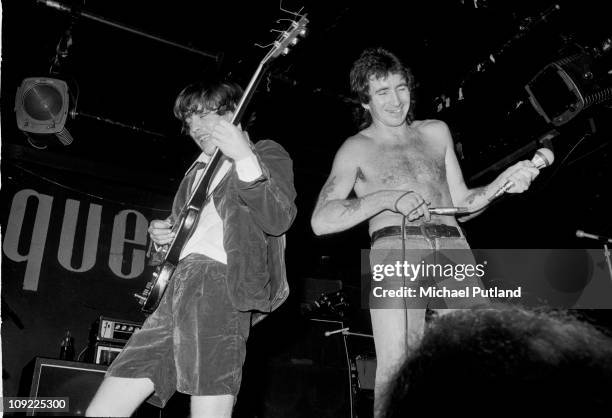 Perform on stage at the Marquee, London, July 1976, L-R Angus Young, Bon Scott.