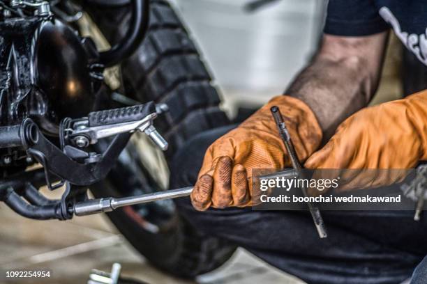 motorcycle inspection and maintenance - motorcycle mechanic stock pictures, royalty-free photos & images