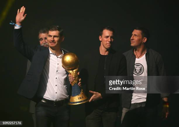 Heiner Brand, Henning Fritz, Dominik Klein and Stefan Kretzschmar bring the World Championship trophy prior to the 26th IHF Men's World Championship...